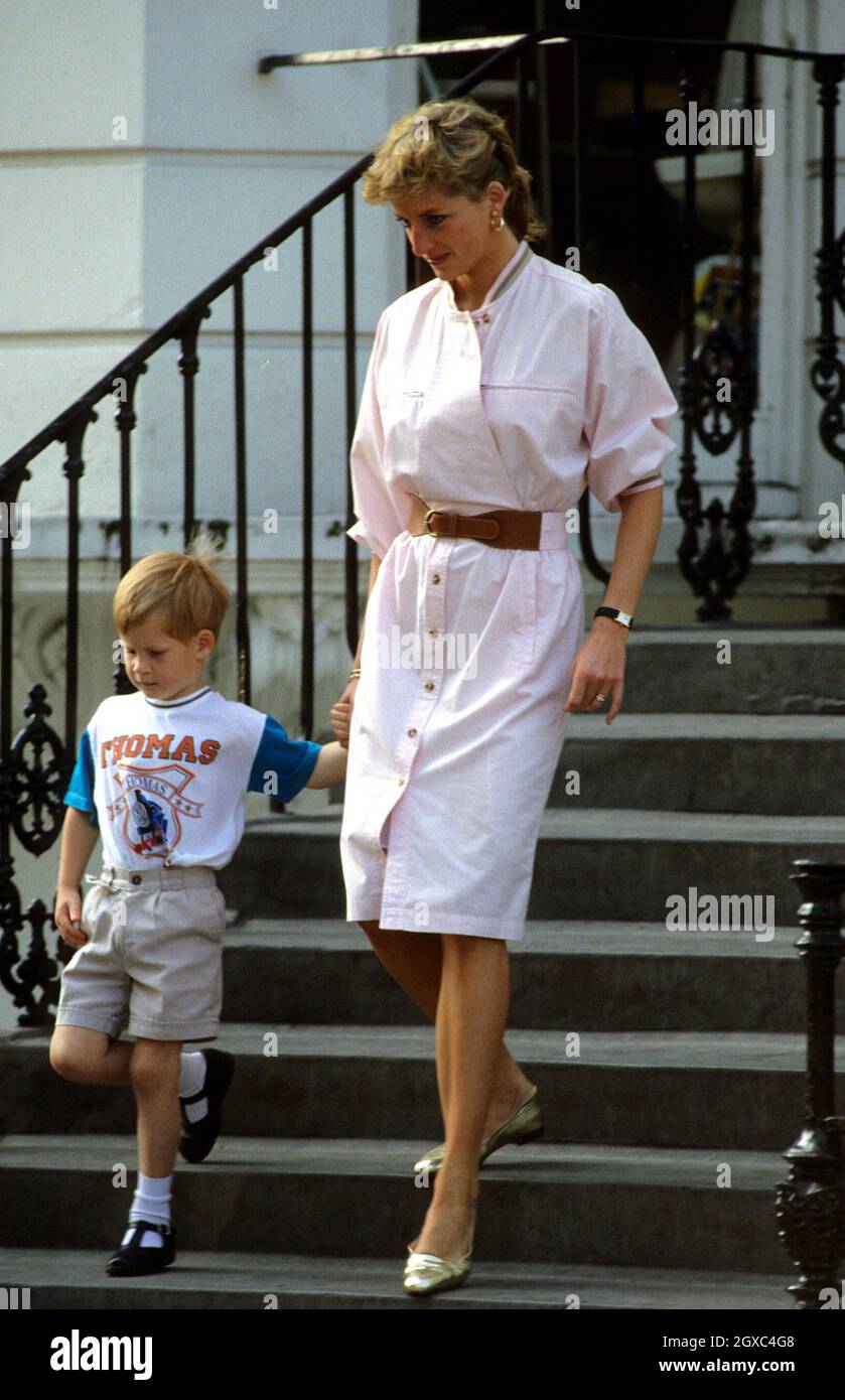 Prince Harry wears a Thomas the Tank Engine t-shirt when he leaves nursery school with his mother Diana, Princess of Wales in June 1989 in London. Stock Photo