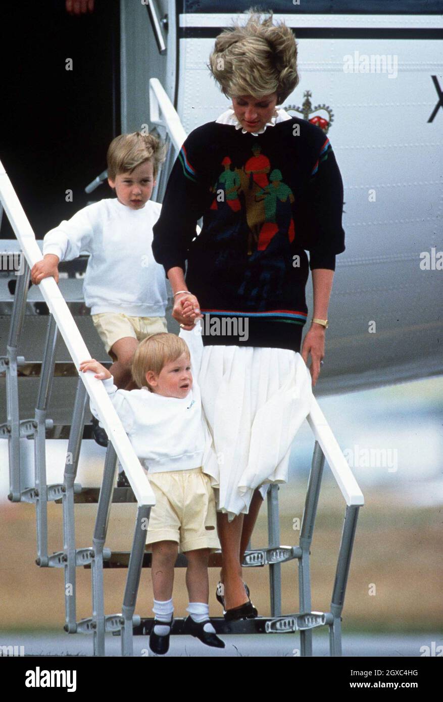 Diana, Princess of Wales, with her young sons Prince William and Prince Harry arrive at Aberdeen Airport for the start of their holidays in Scotland on August 18, 1986. Stock Photo