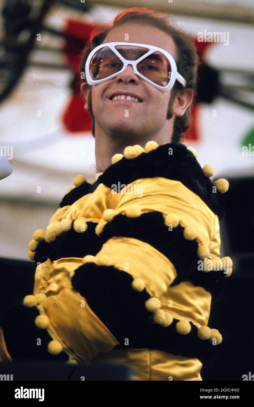 Elton John performs live at an open air concert in Watford in May 1974