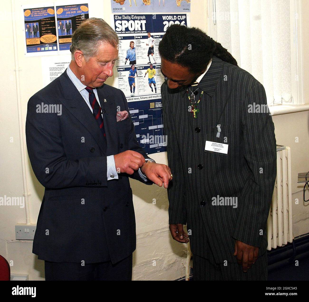 Prince Charles, Prince of Wales meets Erol Graham, one of the first recipients of the Prince's Trust Award 30 years ago, in Toxteth Town Hall community centre, Liverpool on St. Georges's Day, April 23, 2007. The Prince was showing his watch, which, he told Mr Graham, was received as a gift from the Emperor of Ethiopia Haile Selassie. Stock Photo