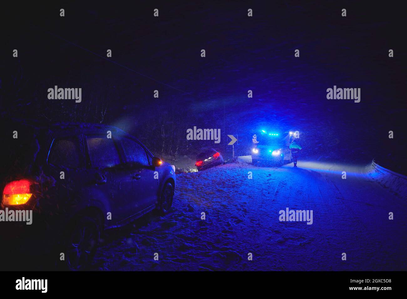 car accident on slippery winter road at night with heavy snow fall and ...