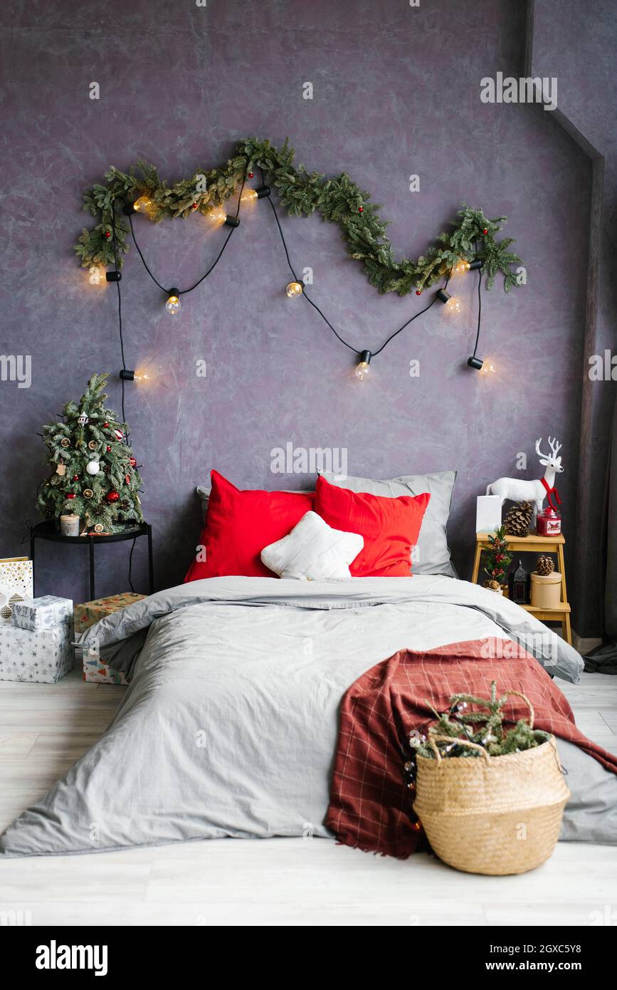 https://c8.alamy.com/comp/2GXC5Y8/stylish-cozy-christmas-bedroom-with-a-large-bed-and-decor-2GXC5Y8.jpg
