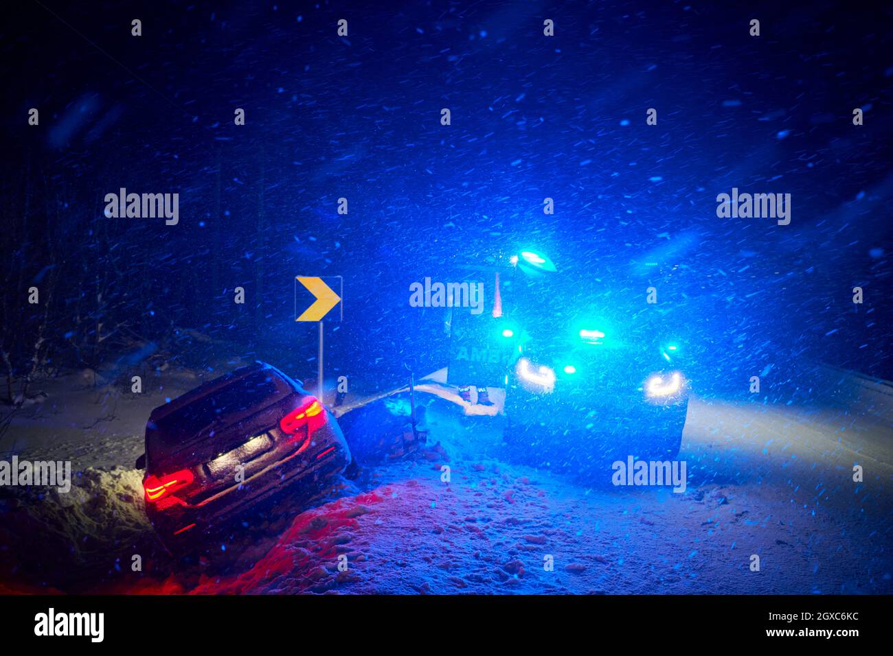 car accident on slippery winter road at night with heavy snow fall and ...