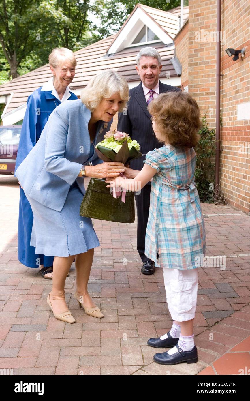 Camilla, Duchess of Cornwall receives a bouquet of flowers from 8 year old Aislin Briggs as she visits Helen and Douglas House, a hospice and respite care centre for children and young adults, in Oxford. Stock Photo