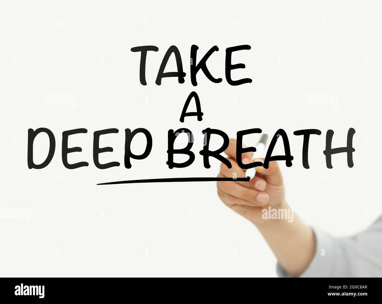 Man writing on a touchscreen with “take a deep breath” text Stock Photo