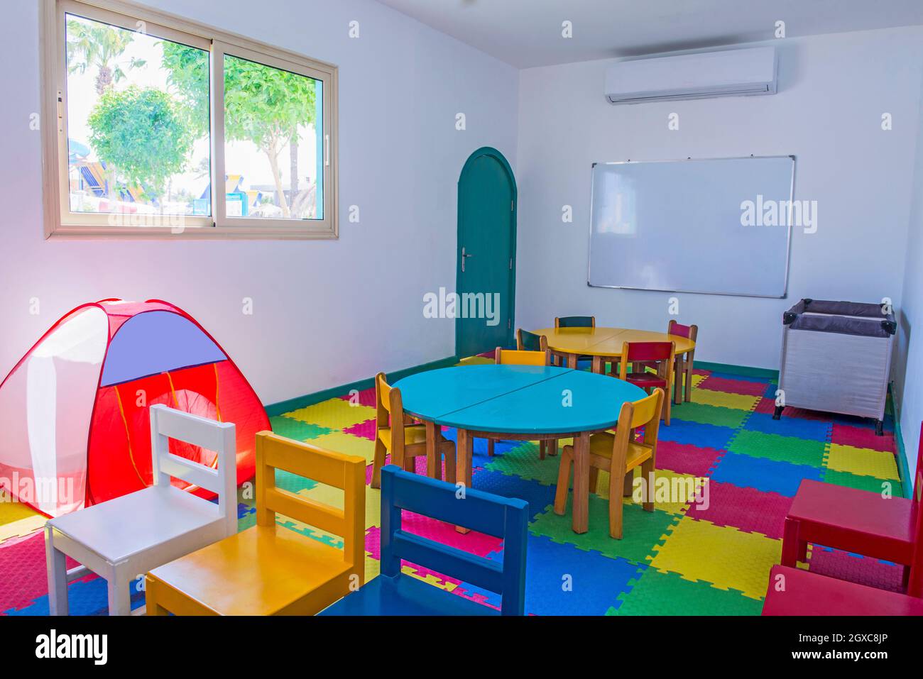 Interior design of large colorful childrens play room area kids club in hotel with games and toys Stock Photo