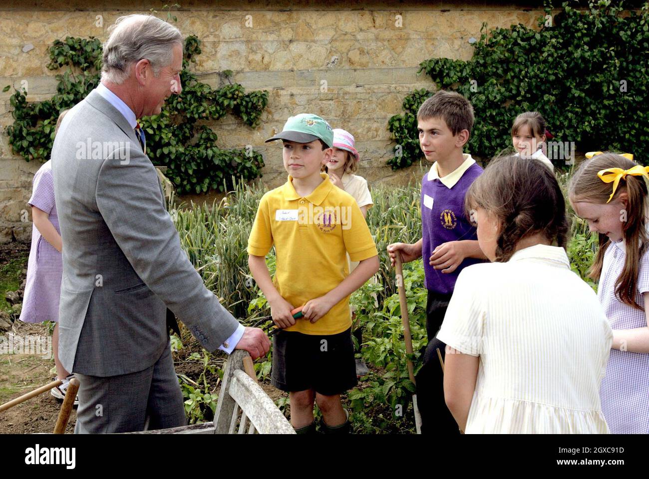 Prince Charles, Prince of Wales chats to children who have their own plot in the kitchen garden at Barrington Court in Barrington. Stock Photo