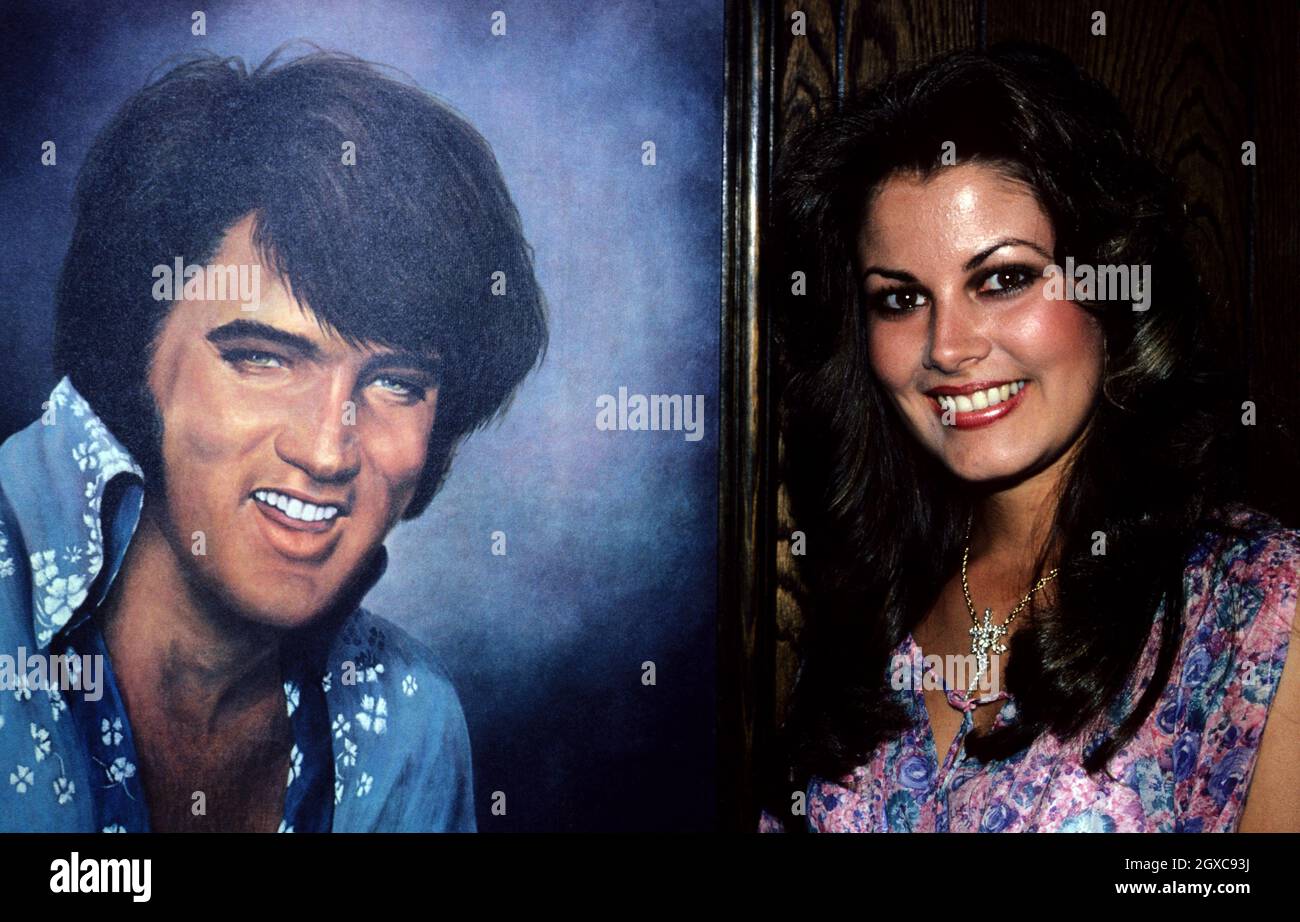 Ginger Alden next to a portrait of boyfriend Elvis Presley, circa 1980