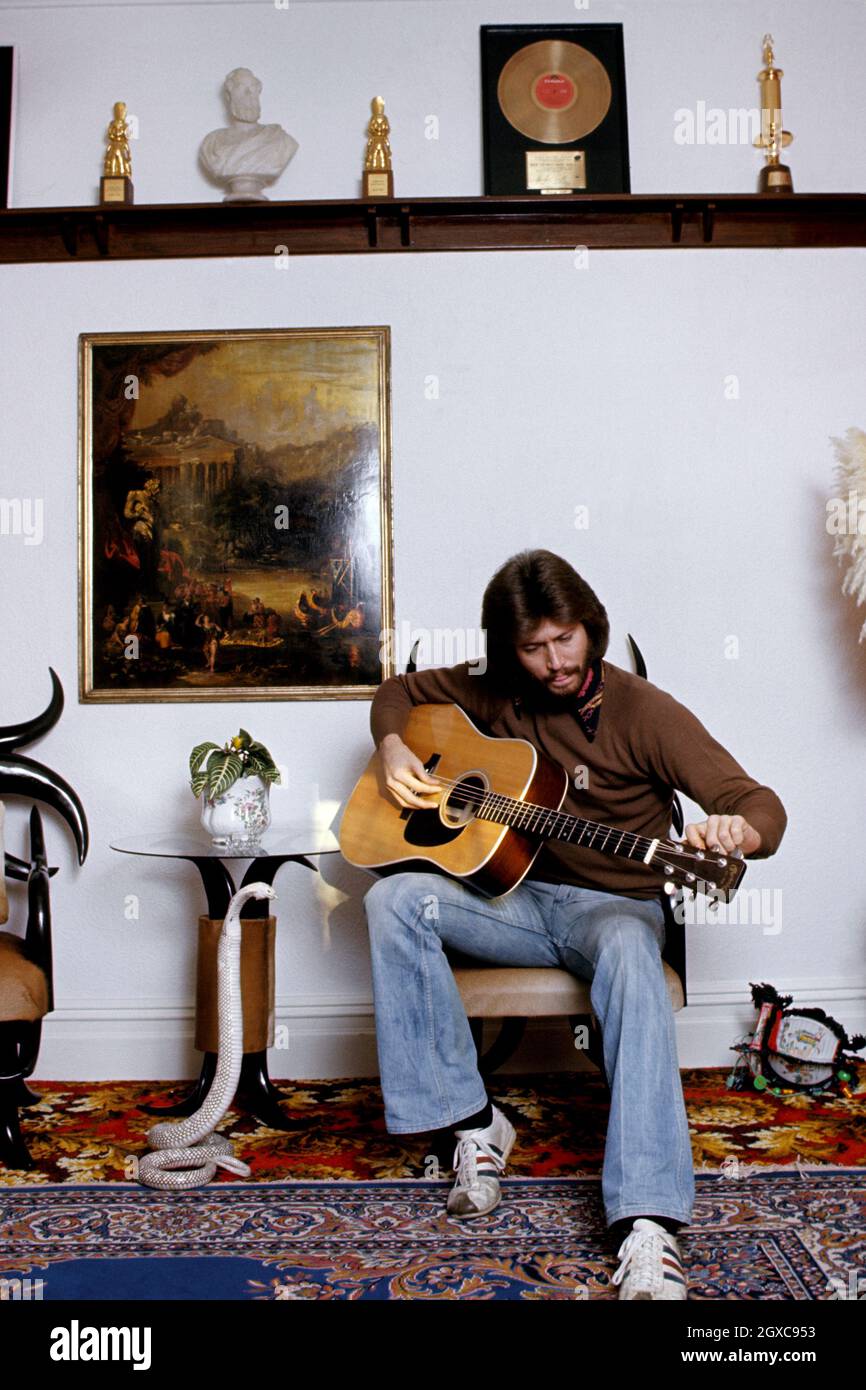 Bee Gees Singer Barry Gibb with a guitar in his home, circa 1974 Stock Photo