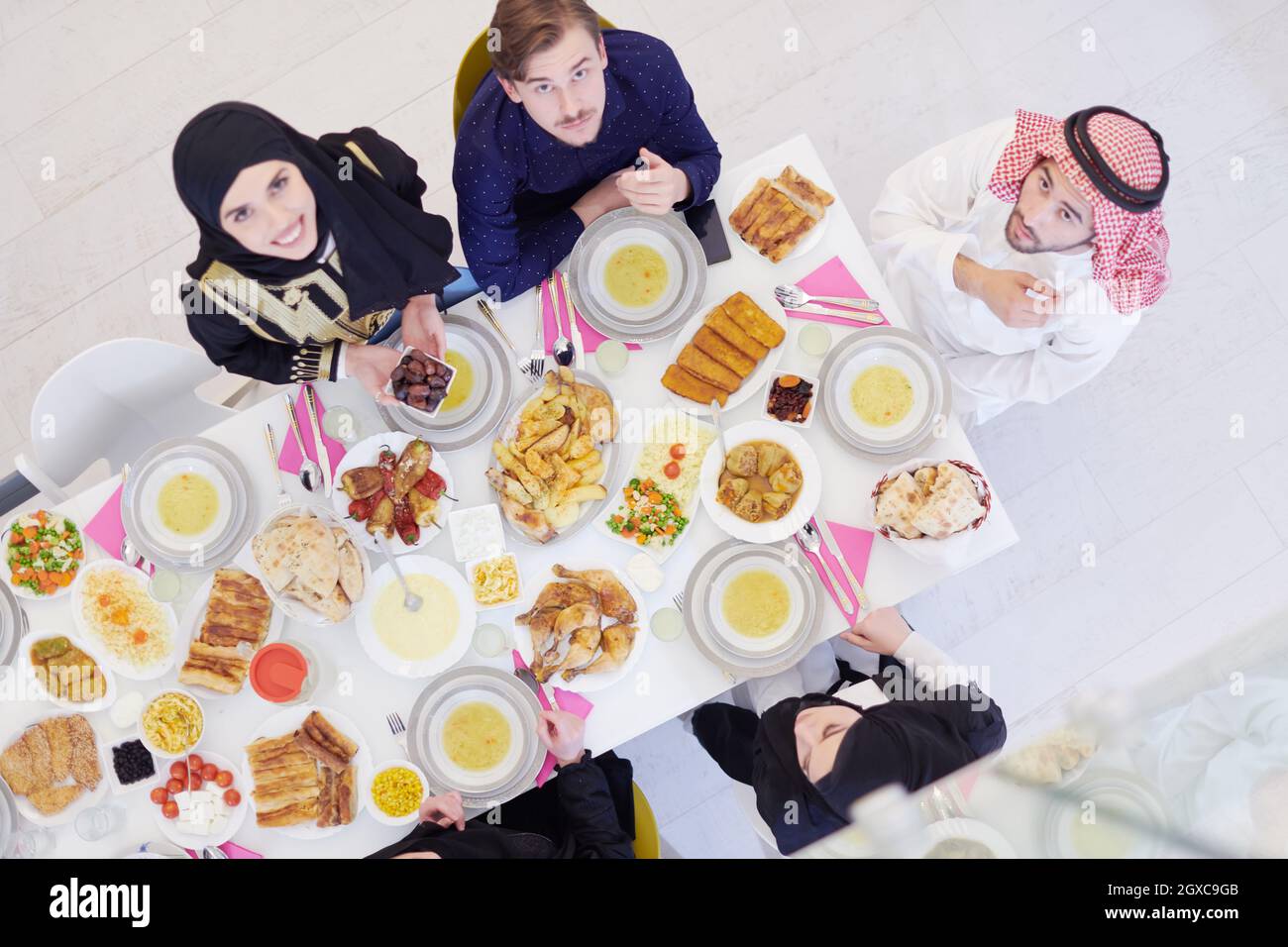 Eid Mubarak Muslim family having Iftar dinner Eating traditional food