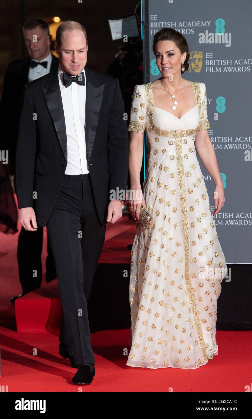 The Duke of Cambridge, President of BAFTA,  and The Duchess of Cambridge wearing a full-length white and gold gown by Alexander McQueen, arrive at the 2020 BAFTA Awards Ceremony at the Royal Albert Hall in London on February 02, 2020. Stock Photo