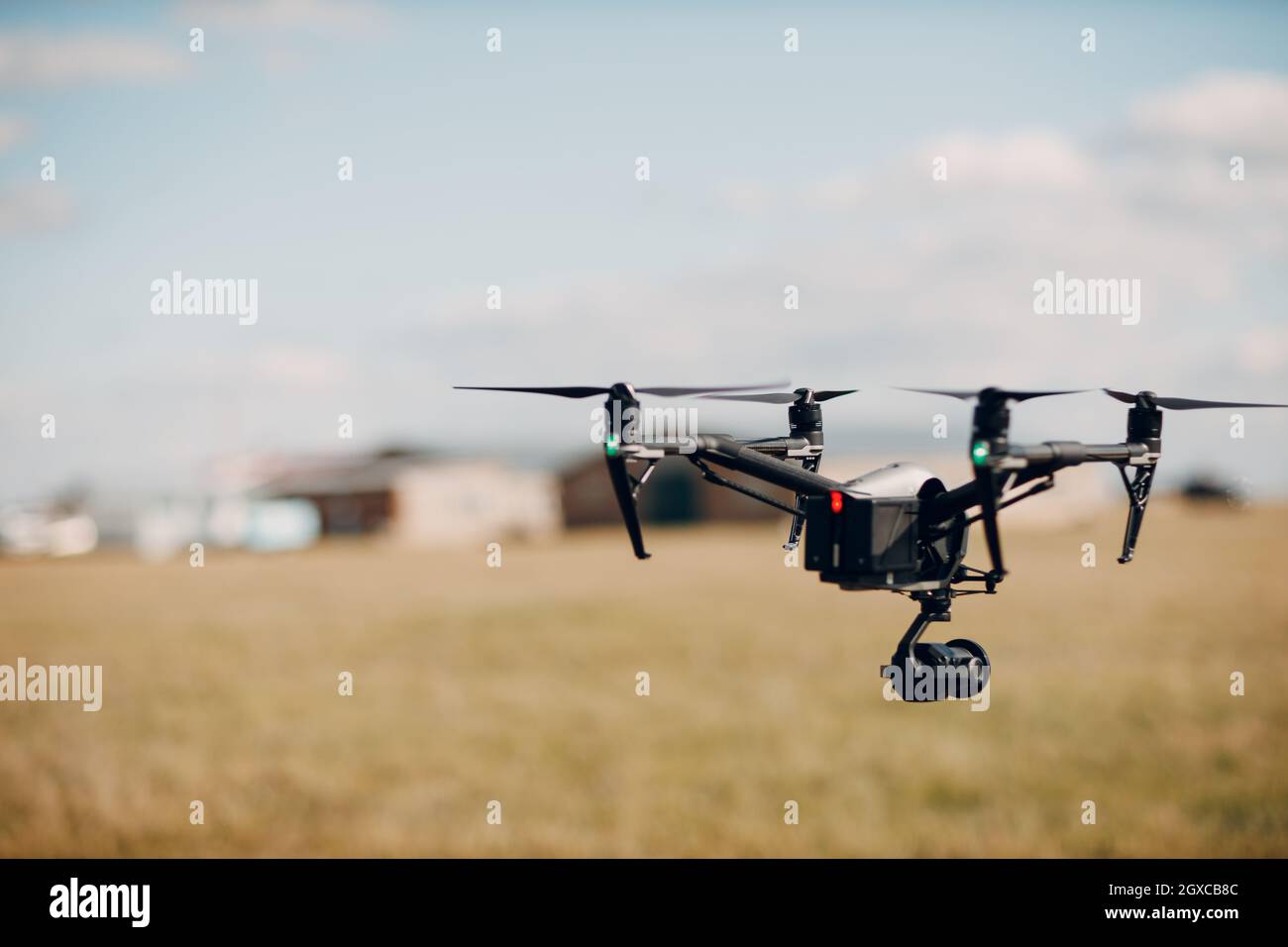 Big quadcopter drone on aerial flight and filming. Stock Photo