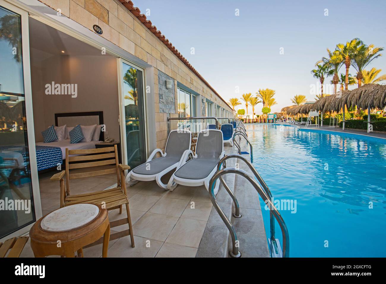 Patio terrace area at luxury tropical hotel resort double room by swimming pool Stock Photo