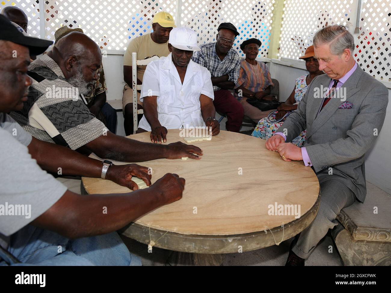 Prince Charles, Prince of Wales plays a game of dominoes with local men at a community centre in Montserrat on March 8, 2008. *** Local Caption *** Stock Photo