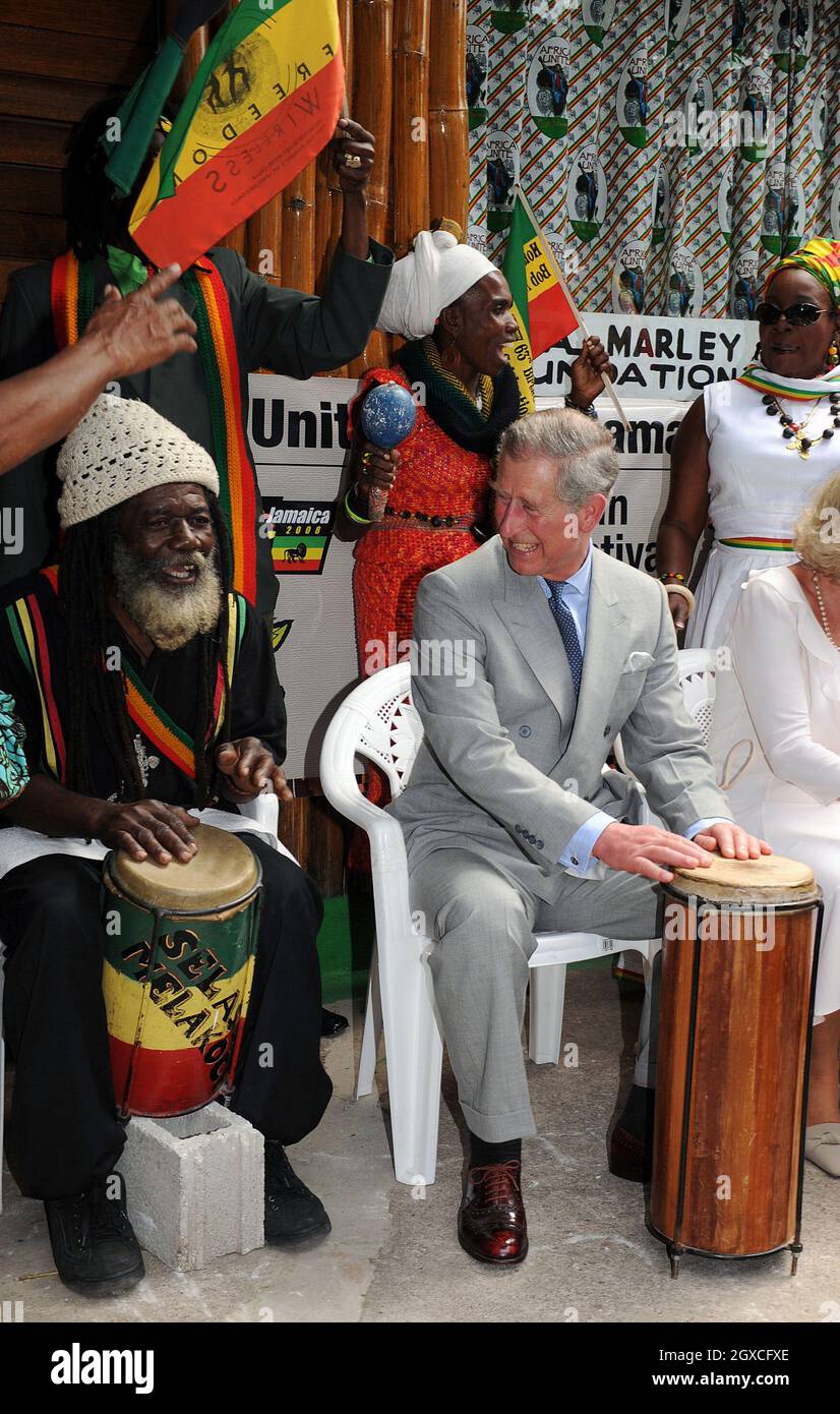 Prince Charles, Prince of Wales plays the bongo drums as he joins a