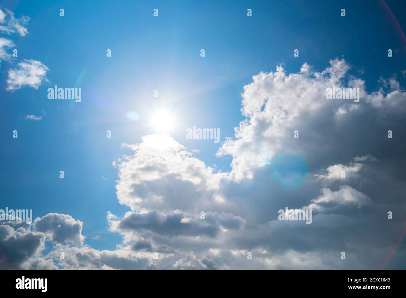 Sun and fluffy clouds Stock Photo