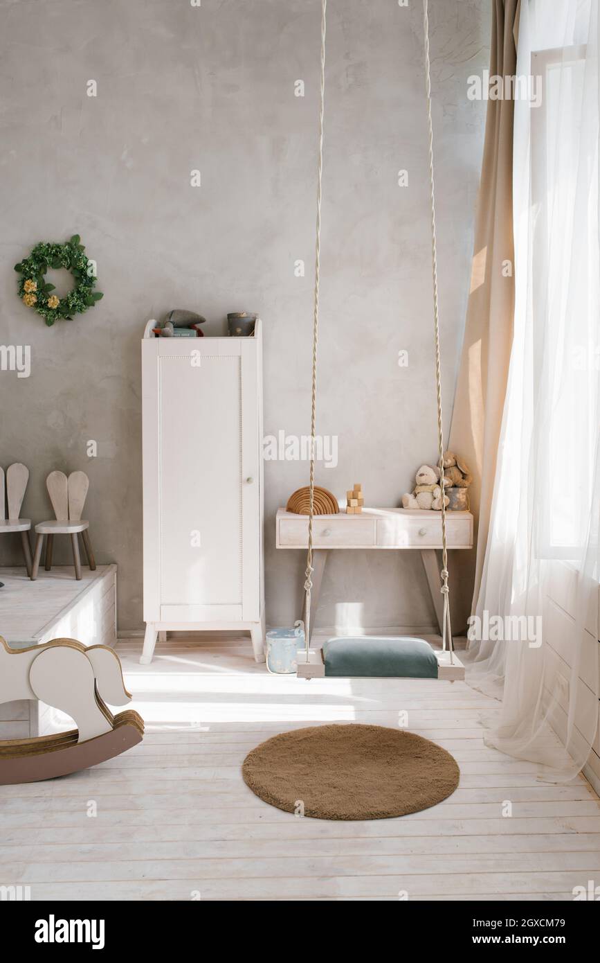 Modern interior of a children's bedroom. Wardrobe, chest of drawers and
