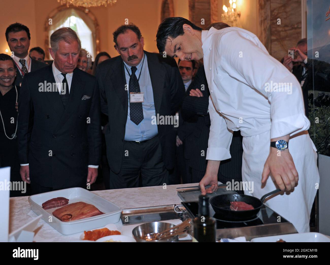 Prince Charles, Prince of Wales watches food being prepared at an organic food reception at the British Ambassador's residence in Rome. Stock Photo