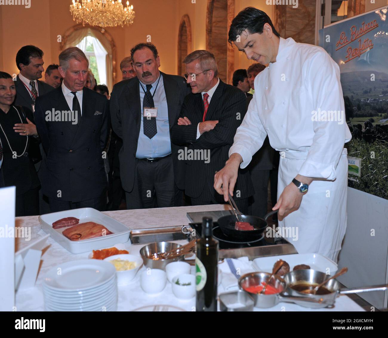 Prince Charles, Prince of Wales watches food being prepared at an organic food reception at the British Ambassador's residence in Rome. Stock Photo