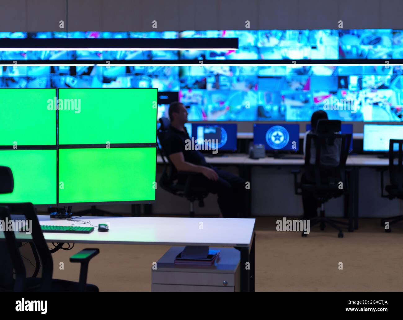 interior of big modern security system control room with blank green