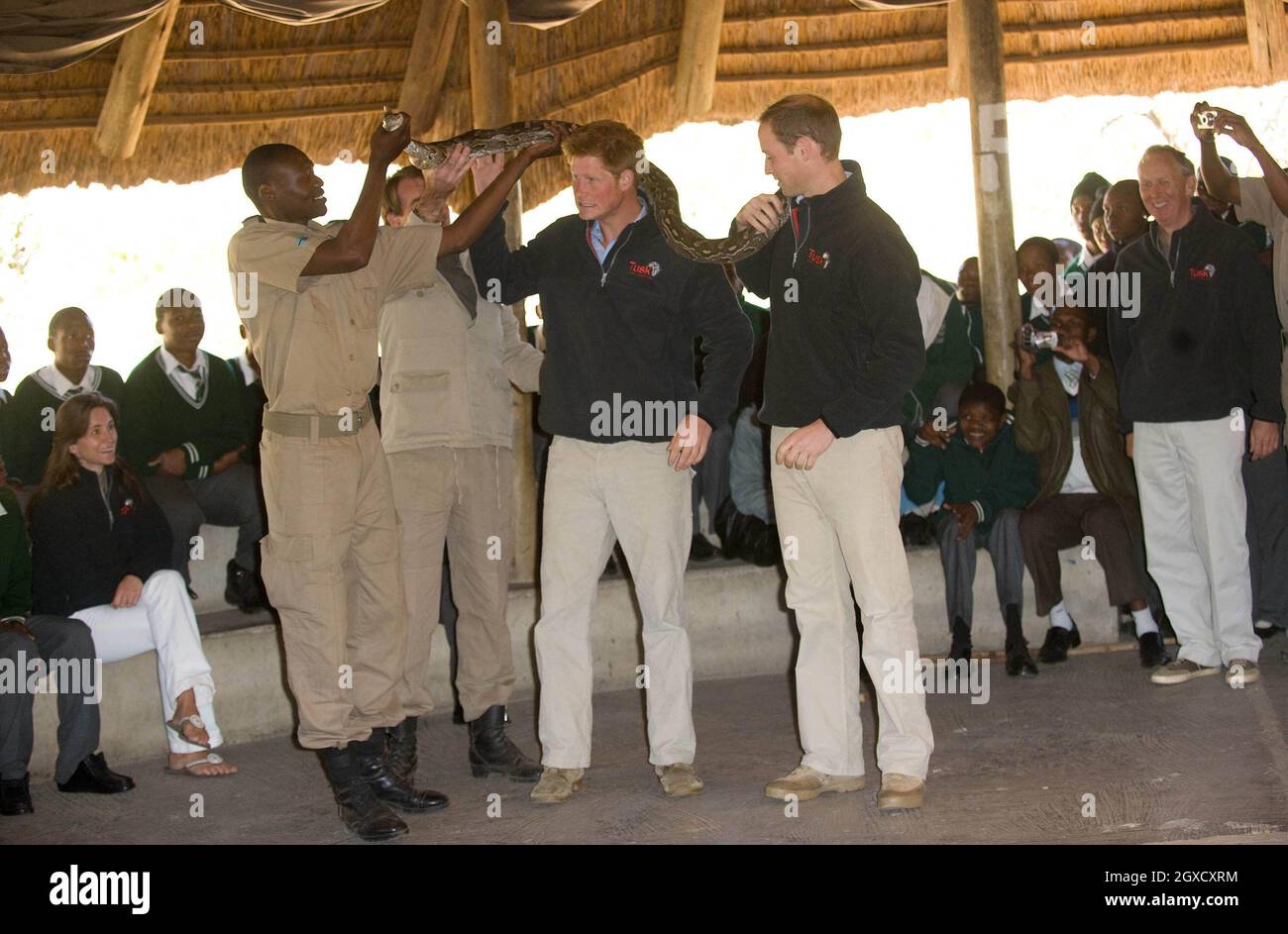 Prince William and Prince Harry pose with an African rock python during ...