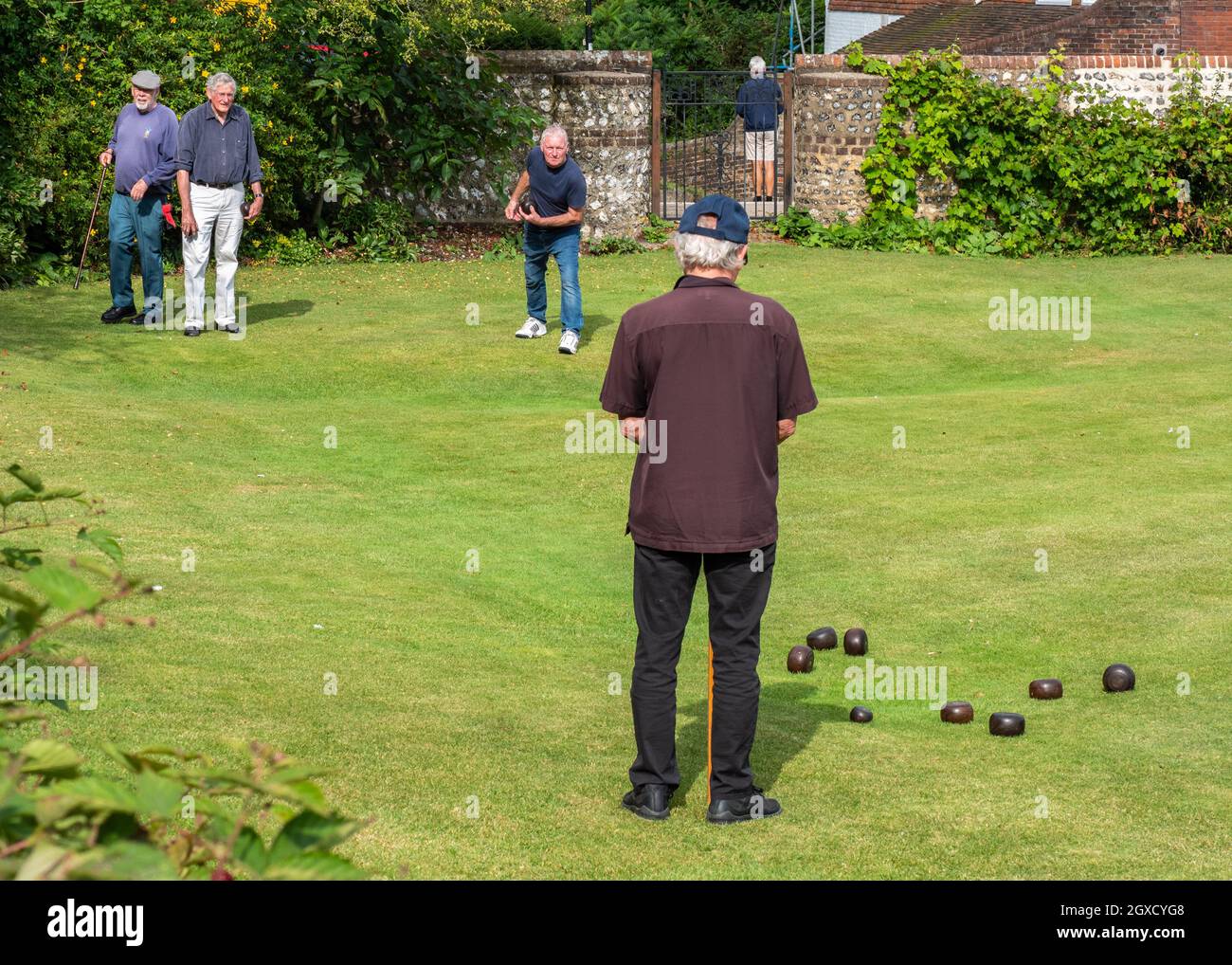 English Crown Green Bowls. A group of senior gentlemen enjoying a game of bowls on medieval lawns of Lewes, East Sussex, England. Stock Photo