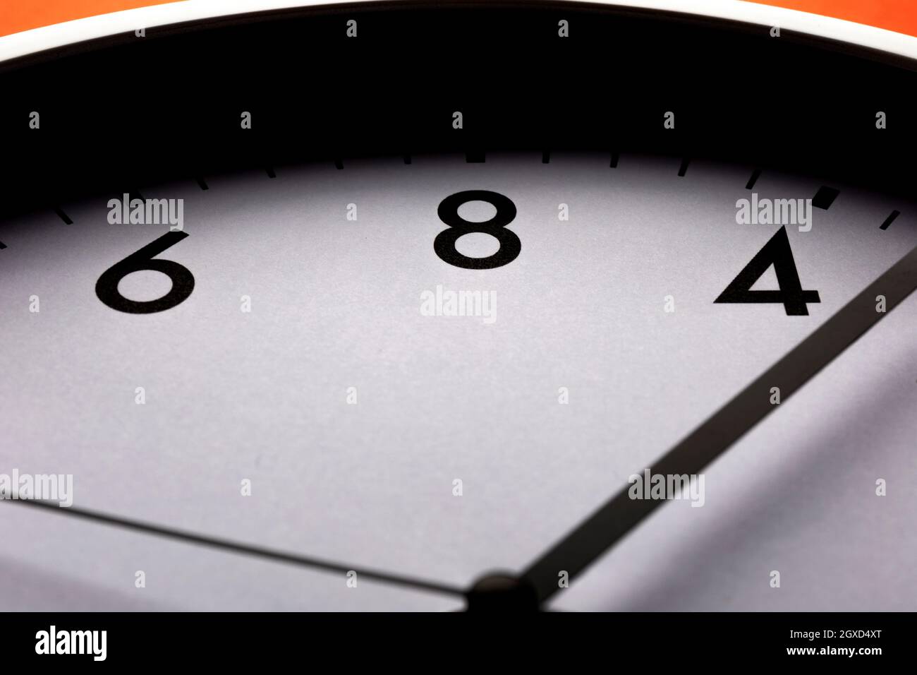 Low angle of clock measuring time with hour and second arrows hanging