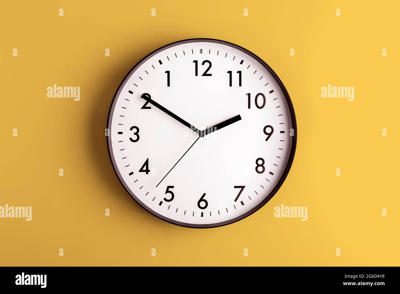 Round shaped minimalistic clock with numbers and arrows on colorful ...