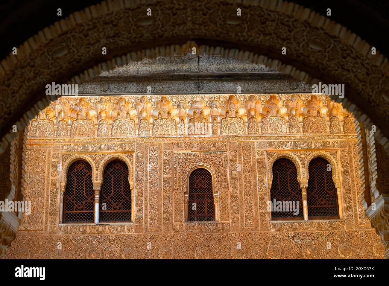 Ornate reliefs cover arches and walls in the Nasrid Palaces of the Alhambra in Granada , Andalusia,Spain. Stock Photo