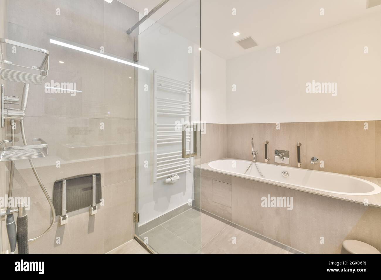 Interior of contemporary bathroom with shower cabin and bathtub