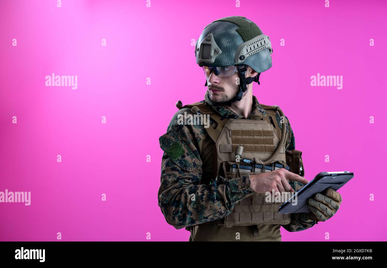 soldier using tablet computer hands closeup pnk background Stock Photo