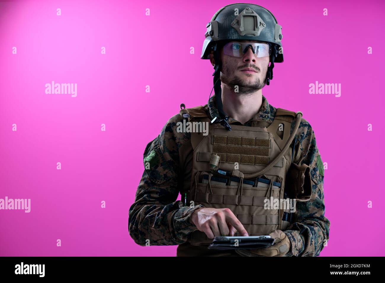 soldier using tablet computer hands closeup pnk background Stock Photo