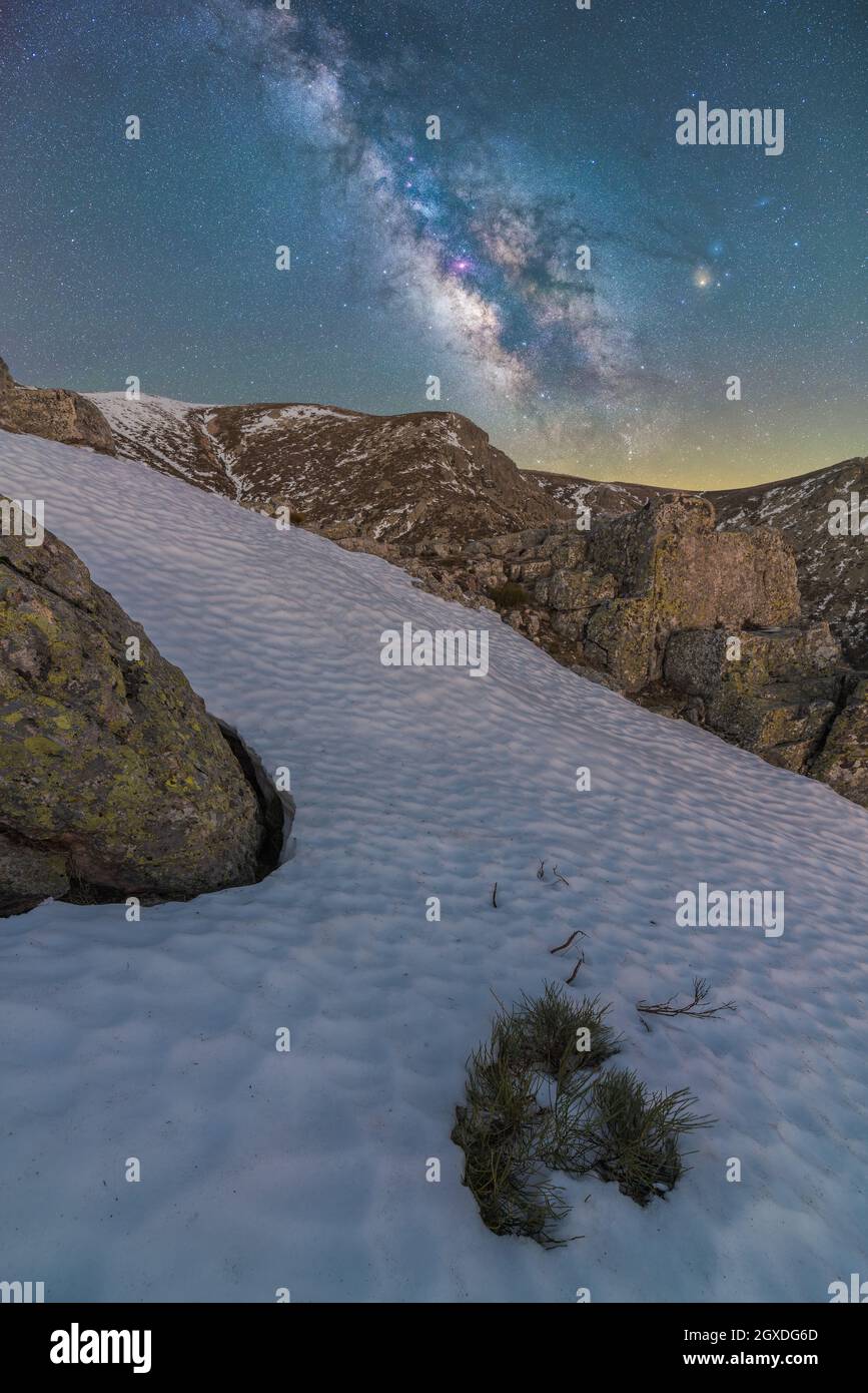 Landscape of snowy valley and mountain under night starry sky with ...