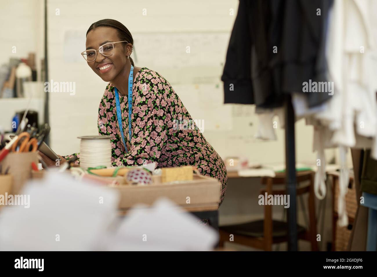 Smiling African female fashion designer using a tablet in her studio Stock Photo