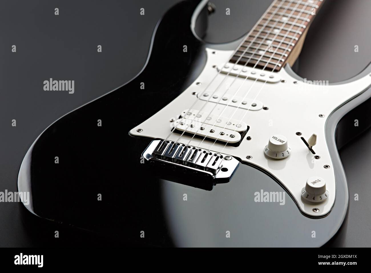 Modern electric guitar, black background, nobody. String musical