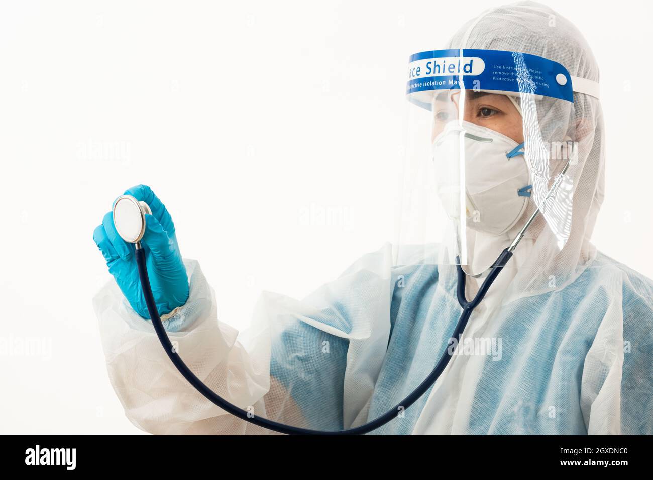 Closeup female medical scientist in PPE uniform wearing a face mask  protective and plastic face shield holding doctor stethoscope on hand for  check Co Stock Photo - Alamy