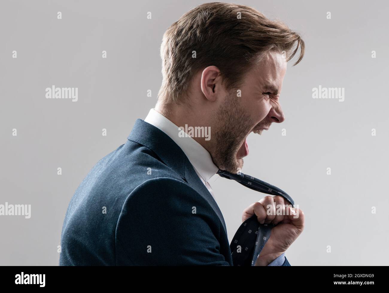 Fight at work. Lawyer scream being pulled by necktie. Physical fight. Angry man screaming Stock Photo