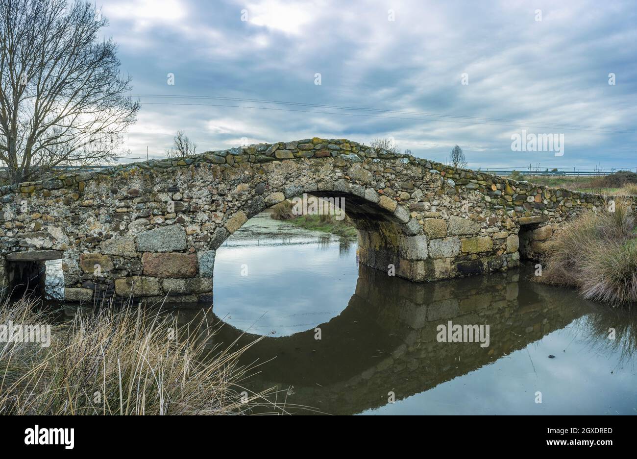 Medieval bridge of Santiago de Bencaliz near the village of Aldea del Cano, Caceres, Spain. This is part of the Via de la Plata Way or Silver Route, a Stock Photo
