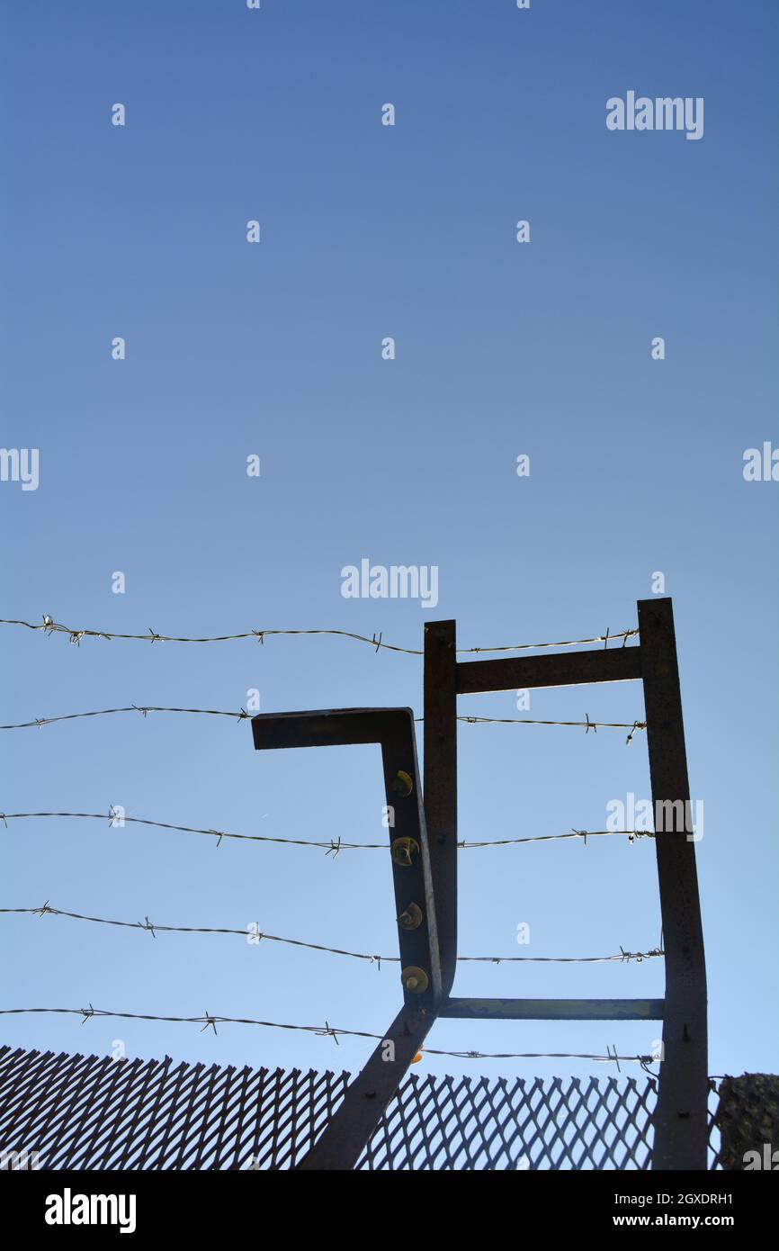 Metal fence with barbed wire on a former border Stock Photo