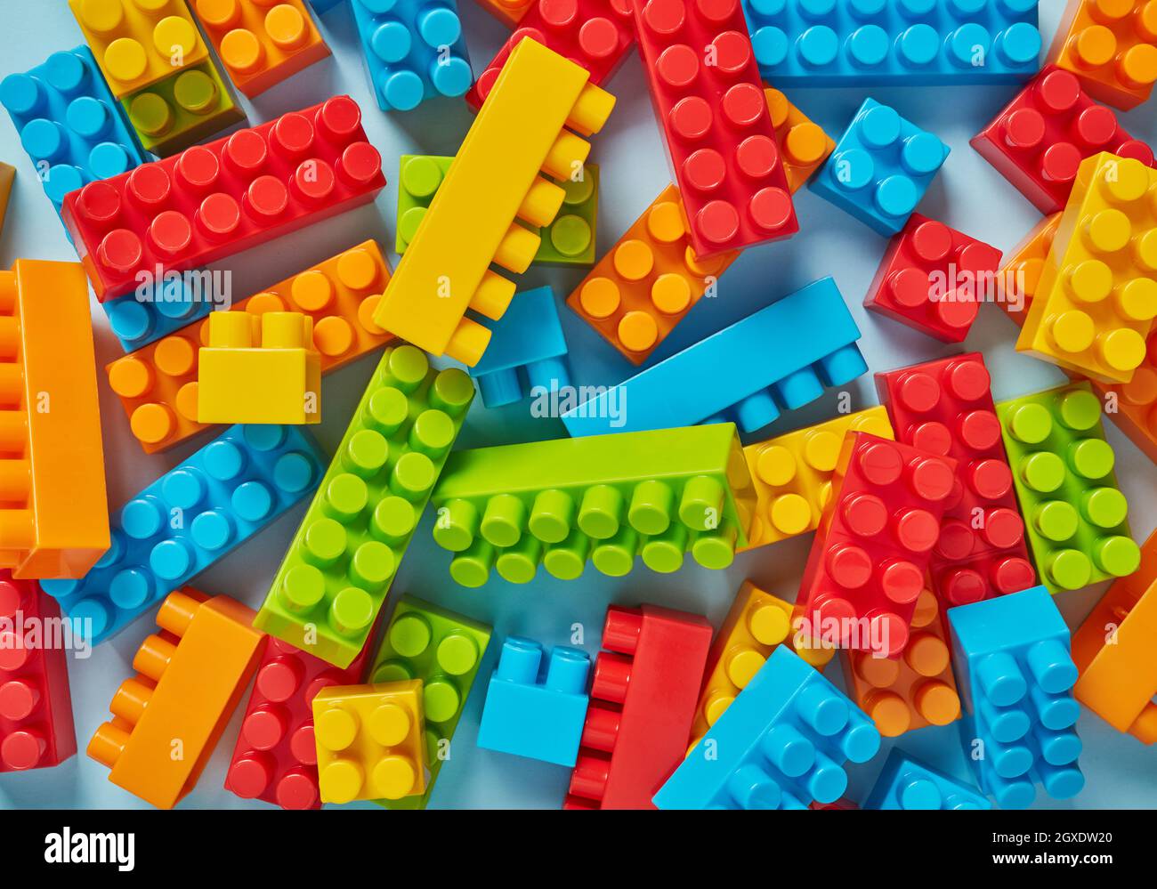 Plastic toy blocks on blue background Stock Photo