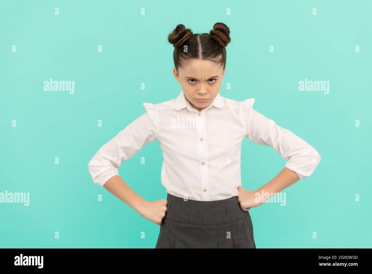 Disobedient girl child back to school standing with arms akimbo blue ...