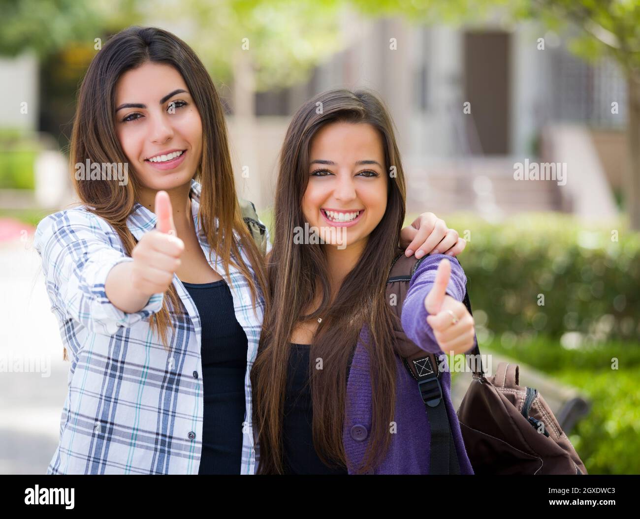 Portrait of Two Attractive Mixed Race Female Students With Thumbs Up ...