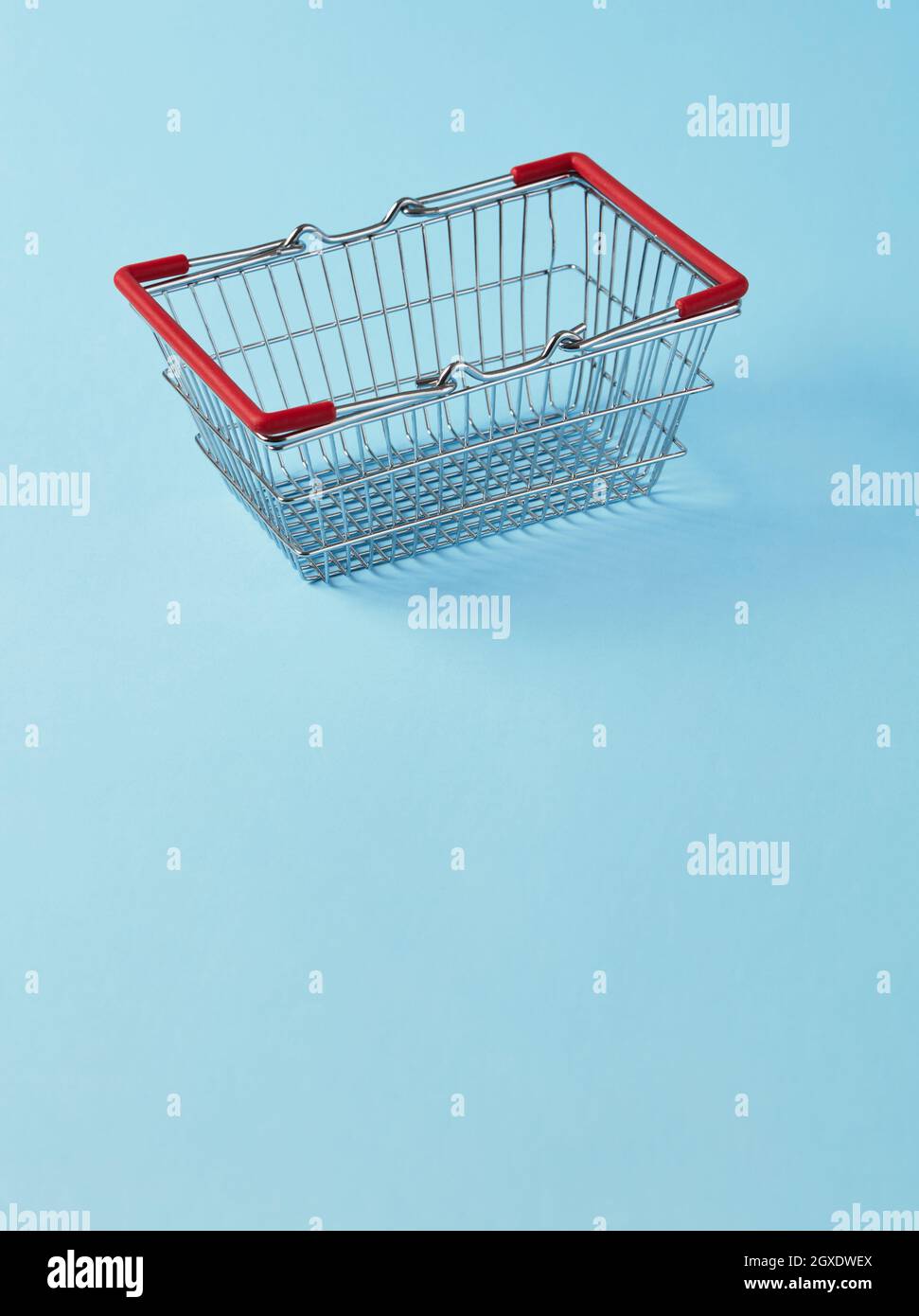 Empty shopping basket on blue background Stock Photo