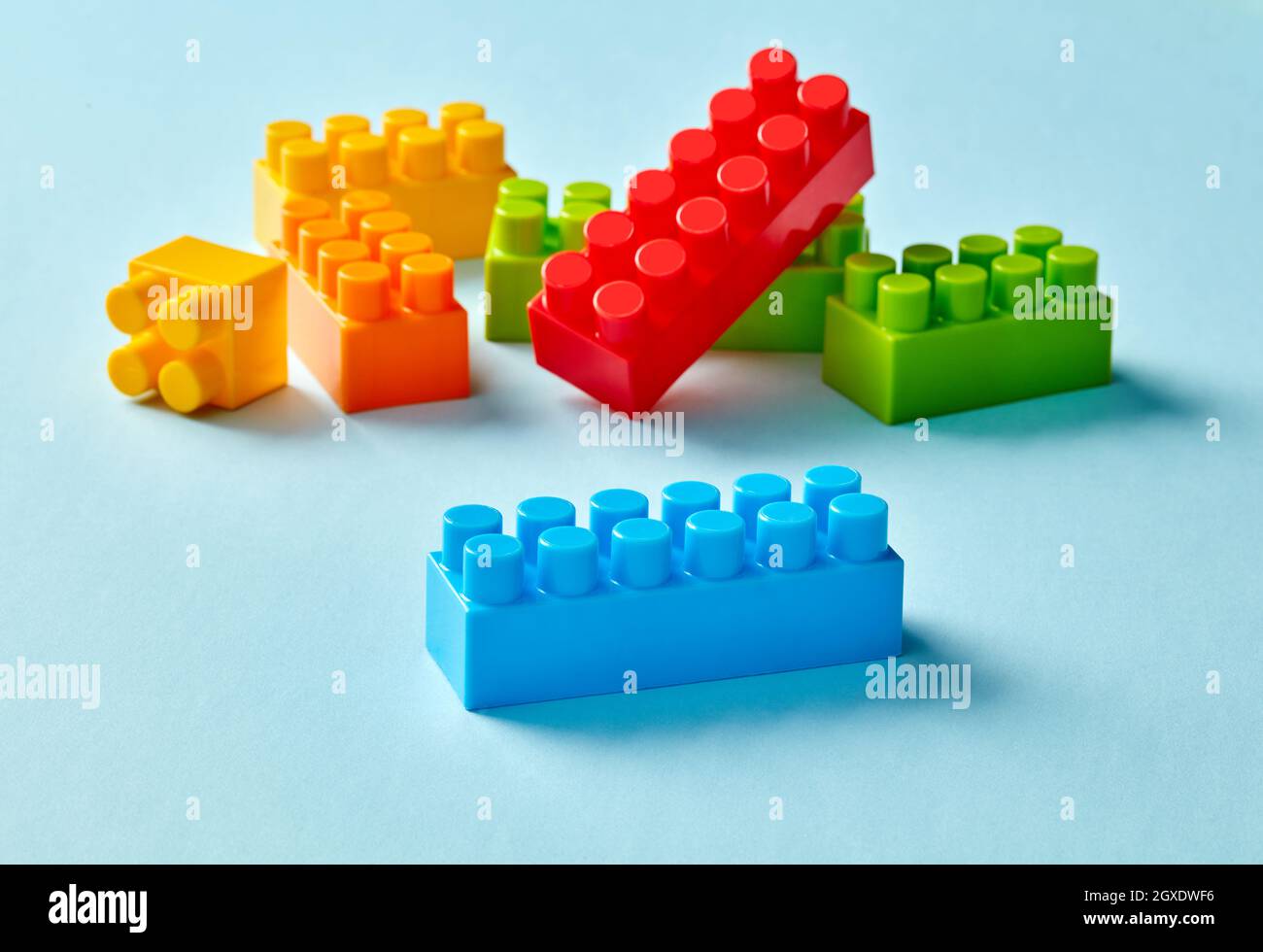 Plastic toy blocks on blue background Stock Photo - Alamy
