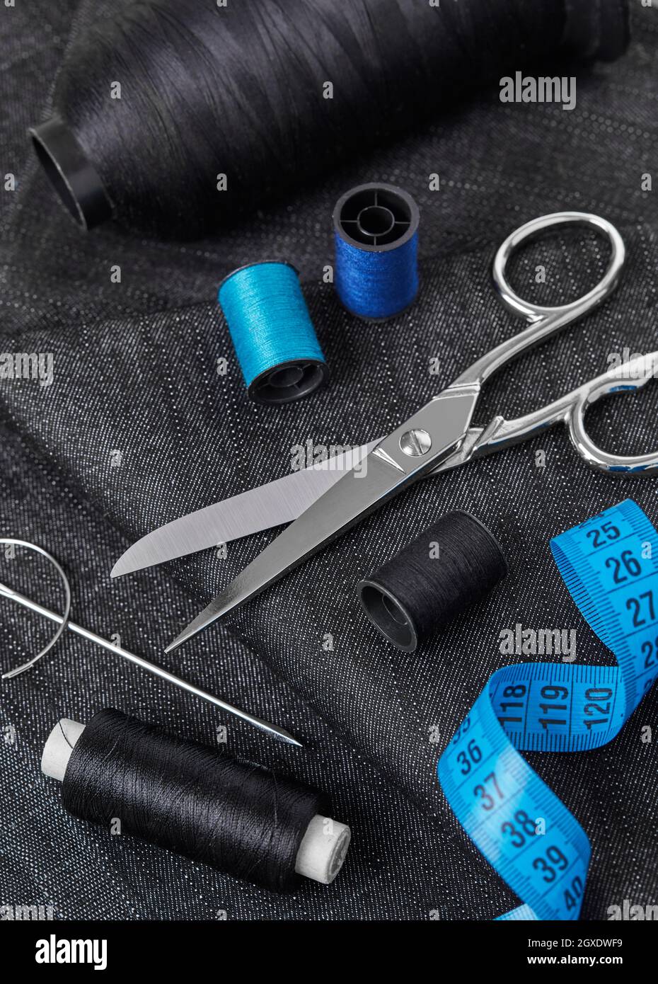 Tailoring thread, scissors, needles, textile and tape measure Stock Photo