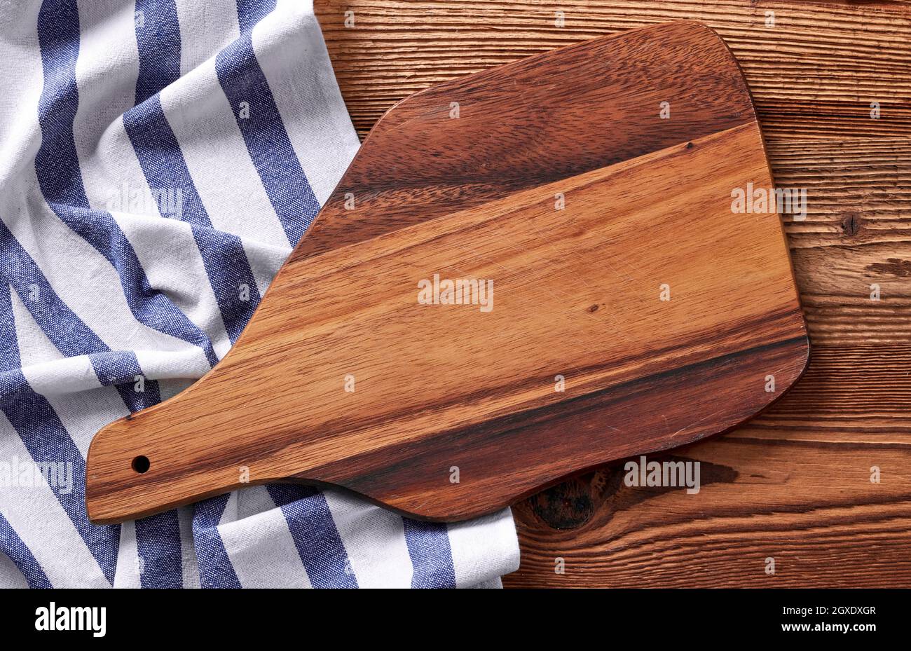 Wooden cutting board on wooden table Stock Photo