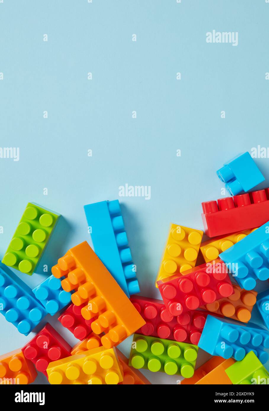 Plastic toy blocks on blue background Stock Photo - Alamy