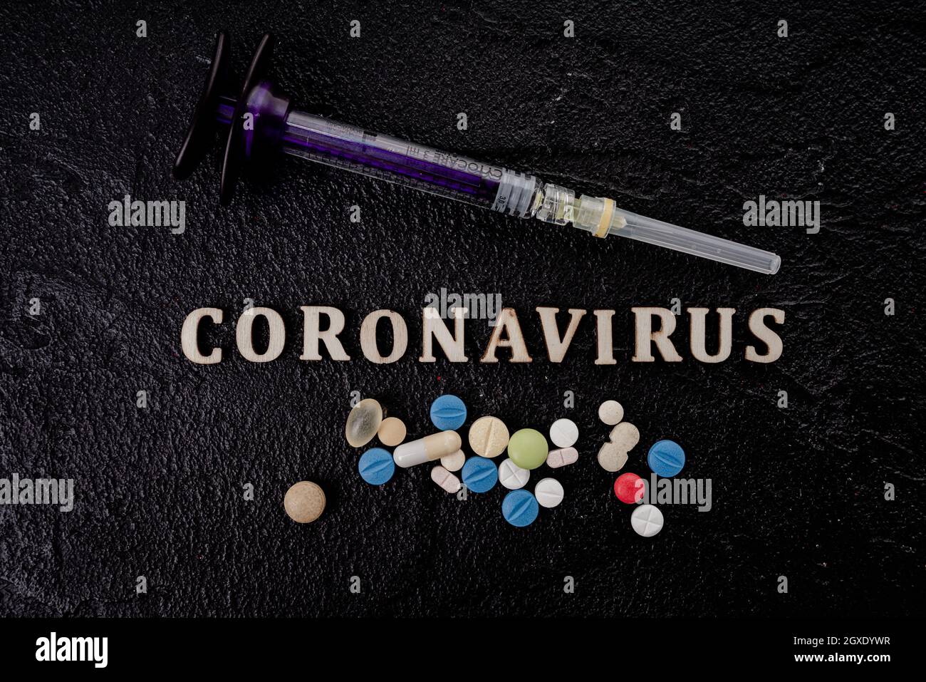 Coronavirus vaccine vial with injection syringe isolated on black ...