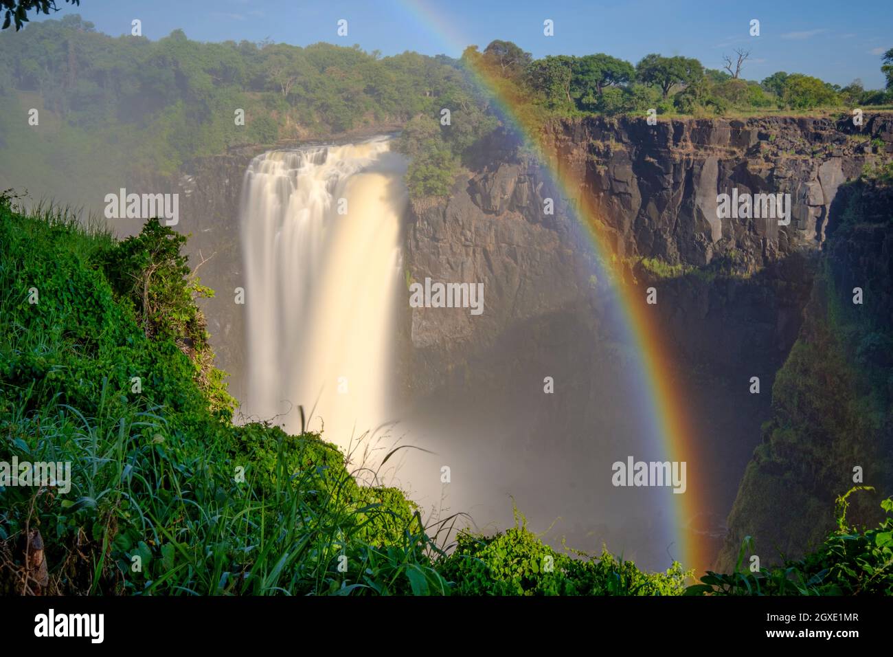 Victoria Falls first Gorge waterfall with rainbow. Victoria Falls National Park, Zimbabwe, Africa Stock Photo