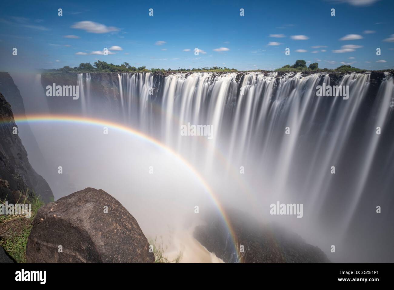 Victoria Falls long Gorge waterfalls with rainbow. Victoria Falls National Park, Zimbabwe, Africa Stock Photo